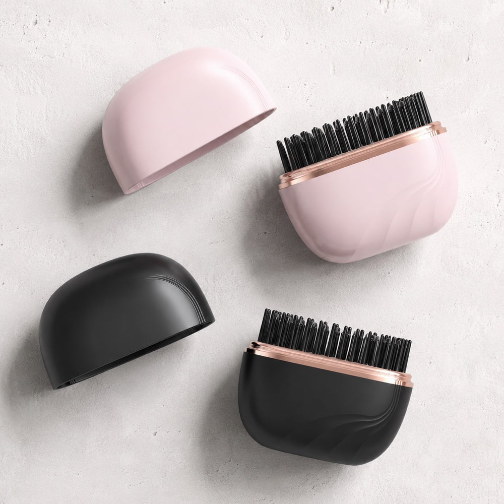Pocket Bunny Mini Hair Brush it in pink and black, with sleek designs and ceramic-coated plates for easy styling.